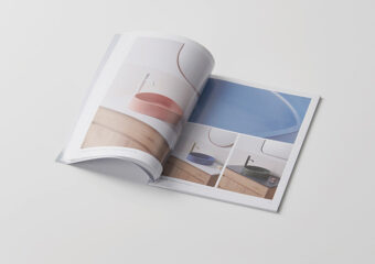 flipped open interior pages of a catalogue book with preview text and a single image of a sink shown