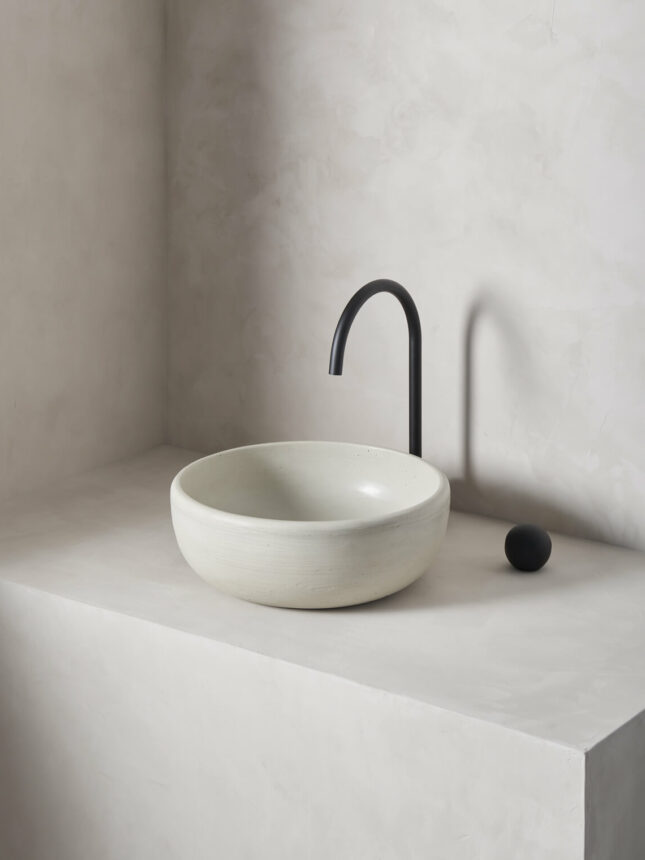 large round bowl sink rove in a micro cement minimalist bathroom in the colour bone with black hardware
