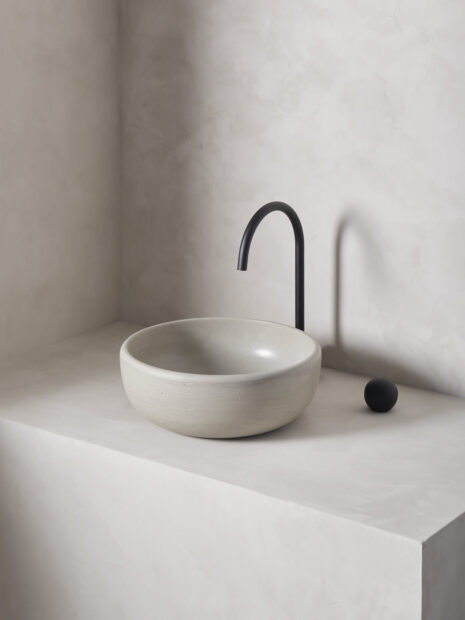 large round bowl sink rove in a micro cement minimalist bathroom in the colour pumice with black hardware