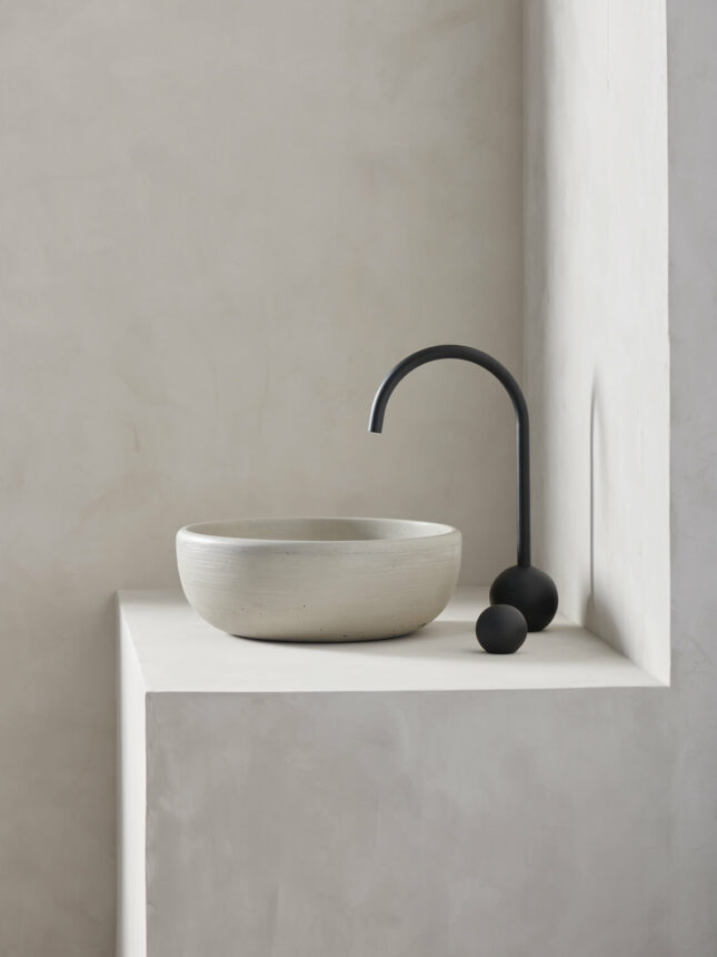 large round bowl sink rove in a micro cement minimalist bathroom in the colour bone with black hardware - photo is shot in side view