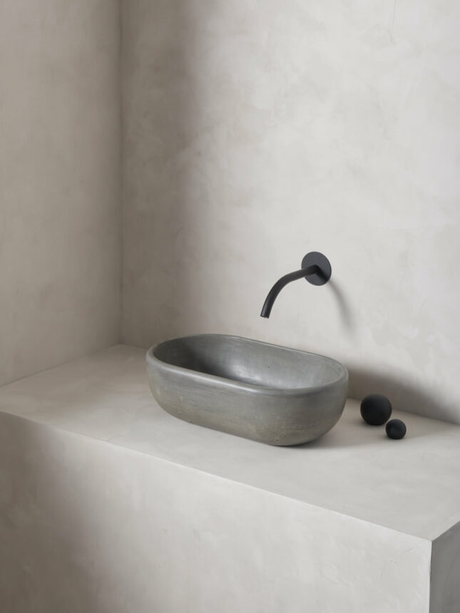 oblong turo sink in a micro cement minimalist bathroom in the colour cliff with black wall mounted hardware