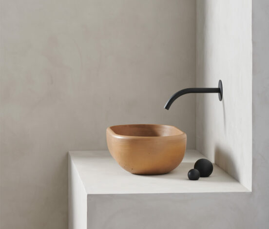 The turo in dune is a petite and obround washbowl with softened curves and high, round-over basin walls - a side view