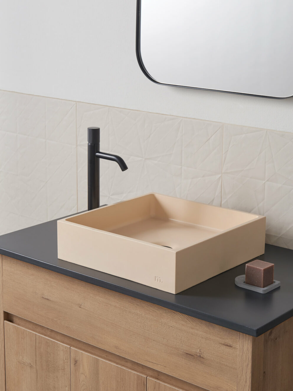 mudd concrete Yarra LG in the colour peach in a modern light bathroom setting with black hardware
