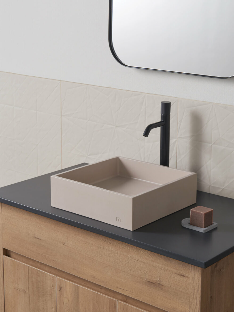 mudd concrete Yarra sm in the colour mocha in a modern light bathroom setting with black hardware