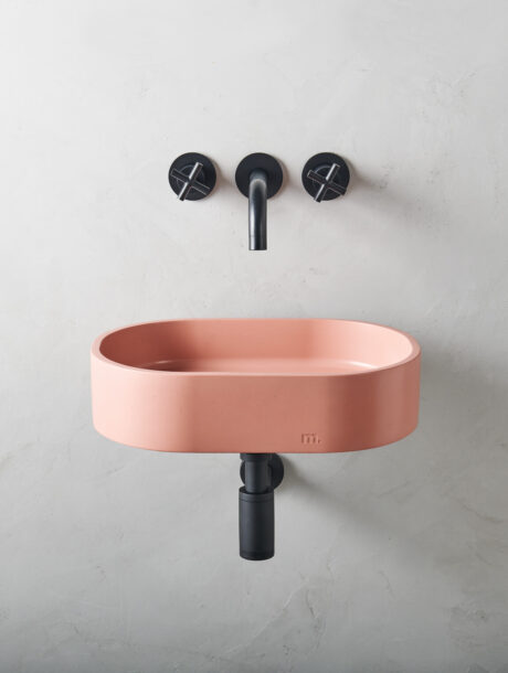 parro affix in mousse set on a bracket on a minimalistic micro cement wall with black wall mounted hardware/ fixtures