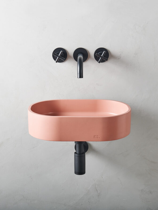 parro affix in mousse set on a bracket on a minimalistic micro cement wall with black wall mounted hardware/ fixtures